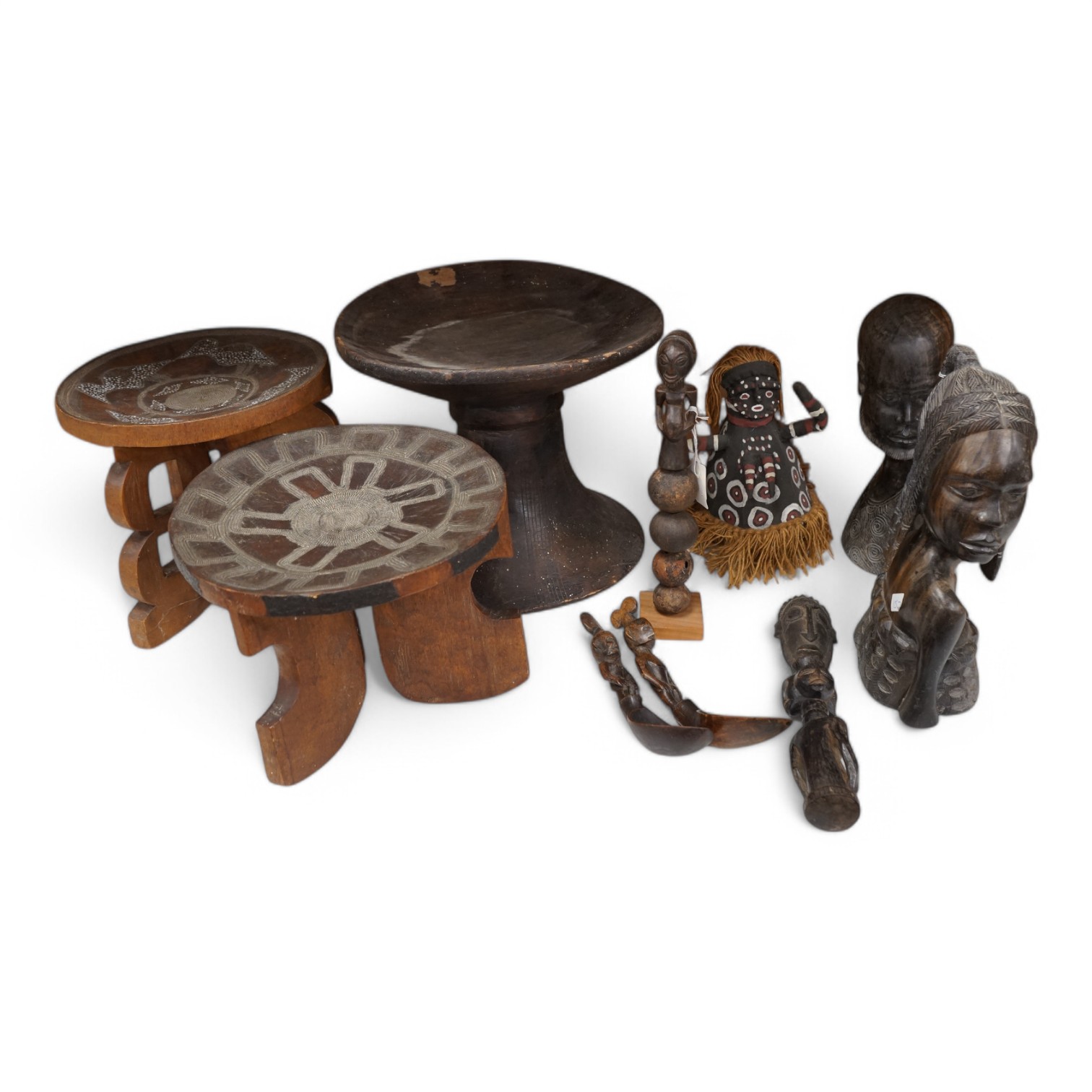 Two African tribal busts, two carved spoons and three carved Kamba Kenyan stools (11). Largest stool 28cm high. Condition - mostly good, some staining to seat of largest stool